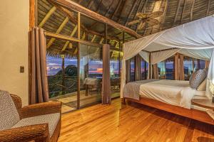 a bedroom with a canopy bed and a balcony at TikiVibez in Coronado +29 photos