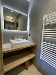 a bathroom with a sink and a mirror at Appartement Haut de Gamme neuf avec terrasse - 6 personnes - App 103 in Saint-Sorlin-dʼArves