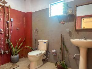 a bathroom with a toilet and a sink at Stay Happy at Chathurni Villa, Ahangama in Ahangama +21 photos
