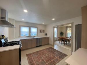 a kitchen with a sink and a stove at Totally renovated large family getaway! King bed 