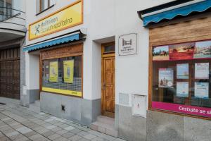 a building with doors and windows on a street at Ubytování Dva v centru in Velké Meziříčí