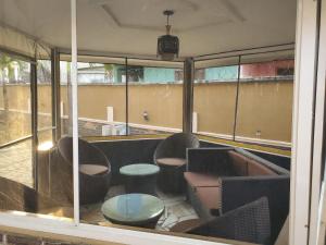 a room with chairs and a table and windows at TwinVilleCove, affordable villas located in Ajah in Aja +134 photos