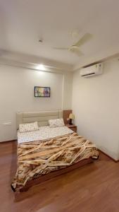 a bedroom with a large bed in a room at paradise stay in Greater Noida