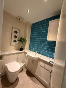 a bathroom with a toilet and a sink at Shenley House with Private Parking Central MK in Milton Keynes