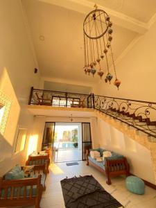 a large living room with a chandelier and a living room at Vipingo Luxury Villa in Kilifi