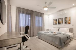 a bedroom with a bed and a desk and a chair at Two Bedroom House In Town Center by Sweet Keys in Limassol