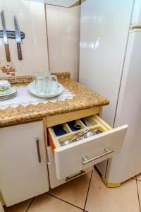 a kitchen with a counter and a refrigerator at Beira Mar e Frente Lagoa de Barra Velha 4 Quartos in Barra Velha