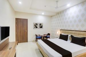 Ένα ή περισσότερα κρεβάτια σε δωμάτιο στο Hotel O GSP Grand +22 φωτογραφίες