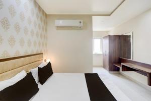 Ένα ή περισσότερα κρεβάτια σε δωμάτιο στο Hotel O GSP Grand