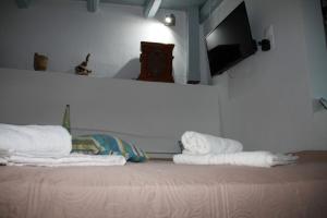 a room with two stacks of towels on a bed at Cavo Paradise Kimolos in Kimolos +38 photos