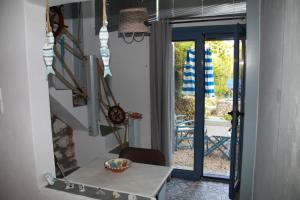 a dining room with a table and a view of a patio at Cavo Paradise Kimolos in Kimolos