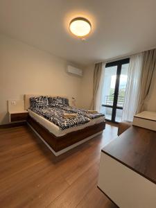 a bedroom with a bed and a large window at New Urban Stay Airport city center metro access in Sofia