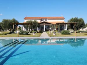 a house with a swimming pool in front of a house at Residence la Pace - Pool & Relax in Marina di Grosseto