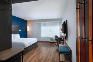 a hotel room with a bed and a desk at Tru By Hilton Irving Dfw South in Irving