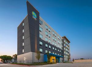 a building with a sign on the side of it at Tru By Hilton Irving Dfw South in Irving