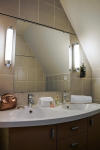 Un baño con dos lavabos y un espejo grande. en ibis Bayeux Port En Bessin, en Port-en-Bessin-Huppain