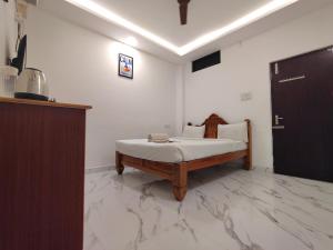 a bedroom with a bed in a room at The Hotel Eden Beach in Puducherry