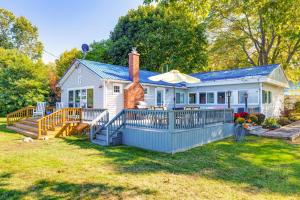 a small white house with a blue fence at Wilson Waterfront Getaway Near Hikes and Wineries! in Wilson