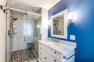 a blue bathroom with a sink and a shower at Wilson Waterfront Getaway Near Hikes and Wineries! in Wilson +17 photos