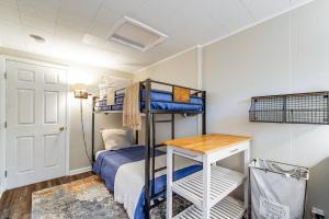 a bedroom with a bunk bed and a desk at Wilson Waterfront Getaway Near Hikes and Wineries! in Wilson