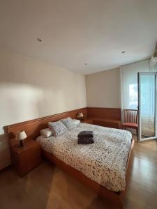 a bedroom with a bed with a black bag on it at Apartamento Rocio en Calella in Calella de Palafrugell