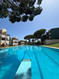 a large swimming pool with blue water at Apartamento Rocio en Calella in Calella de Palafrugell