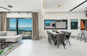 a living room with a table and chairs at Luxury Villa Helena, with heated pool in Makarska