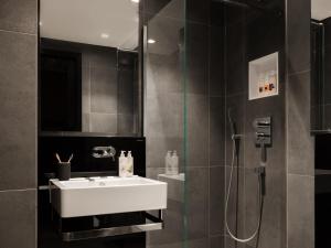 a bathroom with a white sink and a shower at Native Bankside in London +47 photos