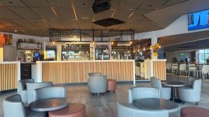 a restaurant with tables and chairs and a bar at Mobil-home 33 st jean de monts camping 5 étoiles in Saint-Jean-de-Monts