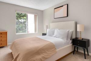 a bedroom with a white bed and a window at Blueground Campbell pool nr Campbell Park SFO-1998 in Campbell +23 photos