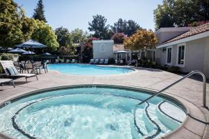 a swimming pool with a hose in a yard at Blueground Campbell pool nr Campbell Park SFO-1998 in Campbell