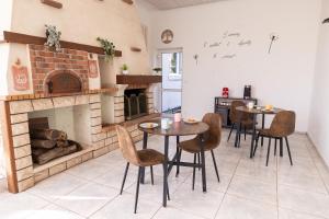 a dining room with two tables and a fireplace at Gîte Mattaincourt in Mattaincourt