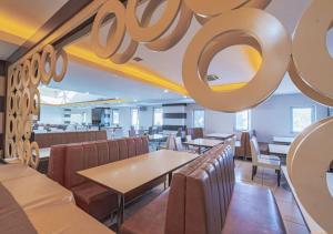 a restaurant with tables and chairs and a large sign on the ceiling at Dora Thermal Tatil Köyü & Spa in İhsaniye