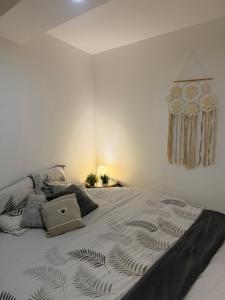 a large bed in a white room with at Cosy Room Trèbes in Trèbes