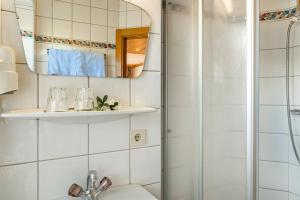 a bathroom with a shower and a sink at Appartement 14 - Haus Voglreiter in Kaprun