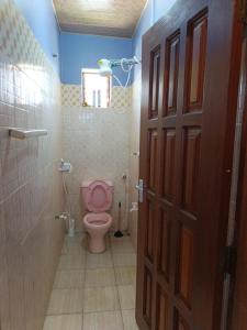 a bathroom with a pink toilet in a room at BnB in Mombasa