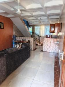 a living room with a couch and a staircase at BnB in Mombasa