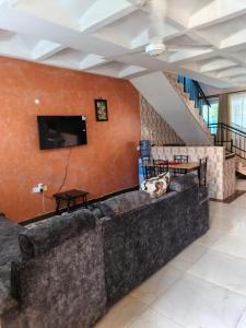 a living room with a couch and a flat screen tv at BnB in Mombasa