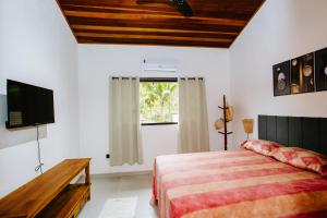 En eller flere senge i et værelse på Casa Camburi