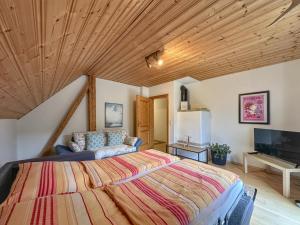 a bedroom with a large bed and a television at Weiherblasch in Dietersdorf