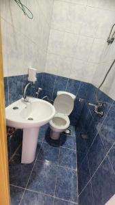 a bathroom with a toilet and a sink at Shapon Hotel - Hurghada in Hurghada