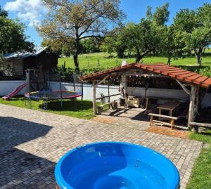 a pavilion with a picnic table and a playground at Chata Chotár Nová Baňa in Veľká Lehota