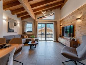 uma sala de estar com um sofá e uma TV em Tauernlodge Eben D4 em Gasthof