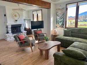 a living room with a couch and a fireplace at Nouveauté Gite la virée verte in Vagney