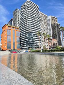 a city with tall buildings and a body of water at La Vita Batumi in Batumi