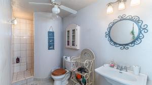 a bathroom with a toilet and a sink and a mirror at Cypress House in Puerto Peñasco +28 photos
