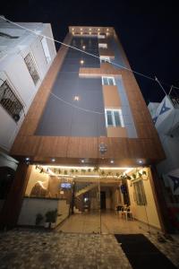 a tall building with lights on it at night at Sri Ganesh Residency in Tirupati