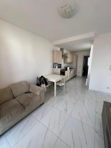a living room with a couch and a table at Jasmine court penthouse in Tal-Ħriereb