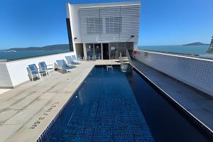 a swimming pool on the roof of a building at Apartamentos Luxuosos a Passos do Mar no Helbor Stay - Airbn Santos in Santos