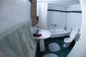 a bathroom with a sink and a toilet and a tub at Comfort Zone - Spacious Apartment in Xanthi in Xanthi +42 photos